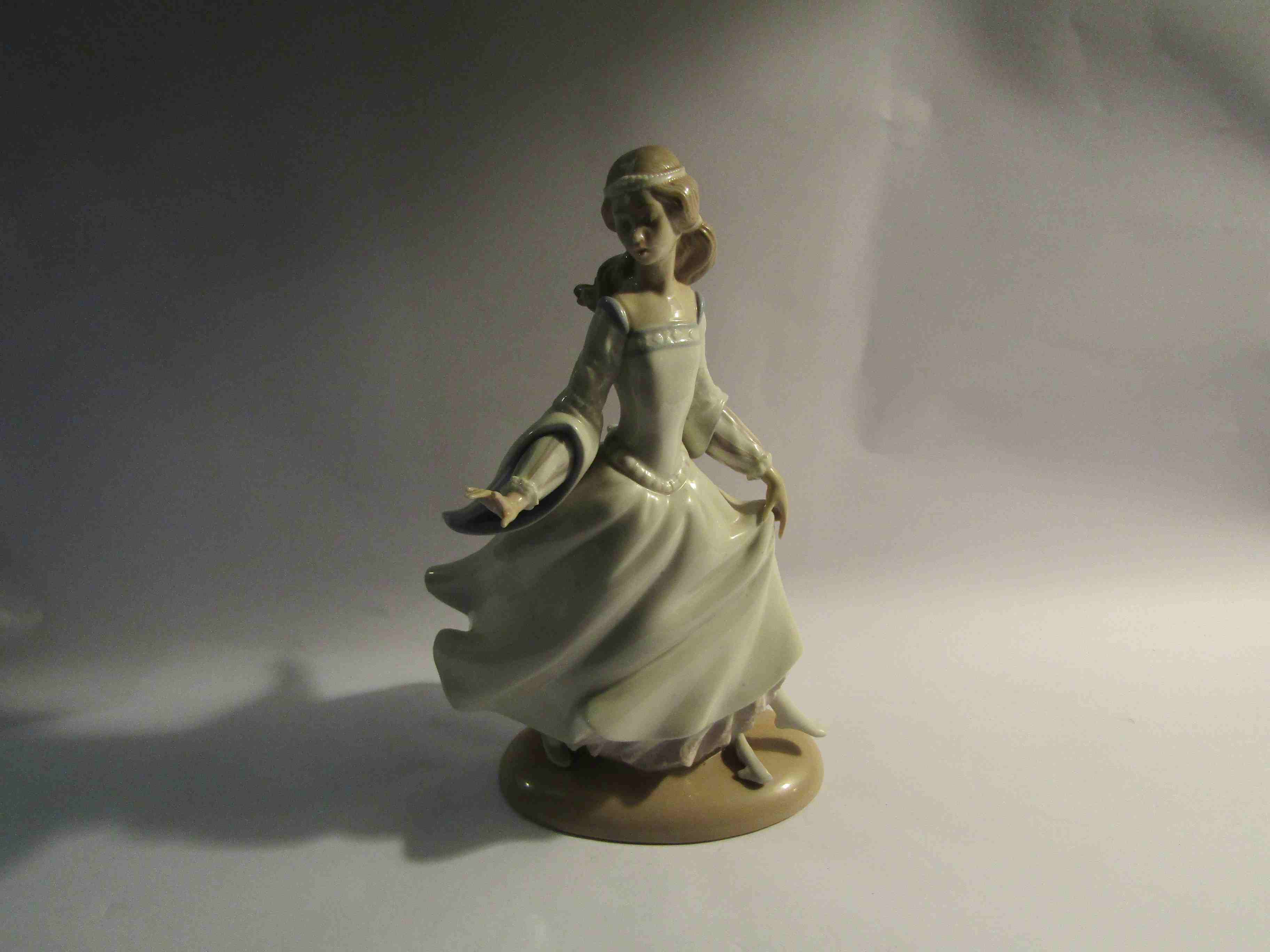 A Lladro figurine of a lady in dress,