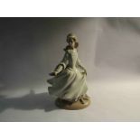 A Lladro figurine of a lady in dress,