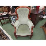 A Victorian walnut spoon back armchair with scroll carved decoration on turned tapering legs and