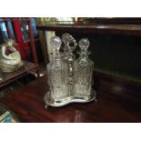 A Victorian silver plated Tantalus with cut glass decanters