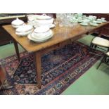 A French oak dining table with two drawers,