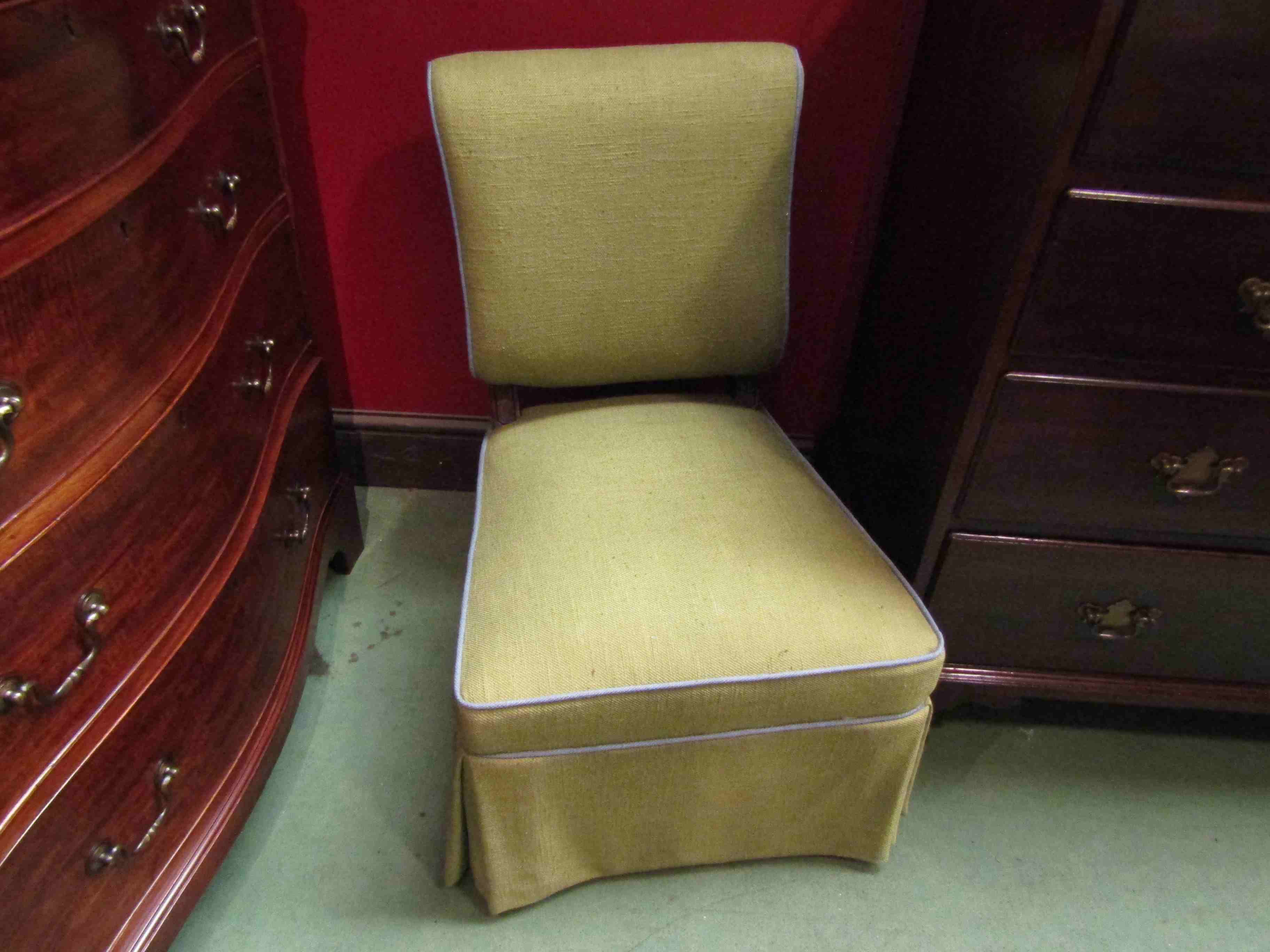 An ebonised and walnut late Victorian open armchair on ceramic castors