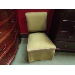 An ebonised and walnut late Victorian open armchair on ceramic castors