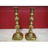 A pair of turned and cast brass candlesticks,