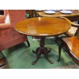 A mahogany oval top occasional table on carved column with four feet