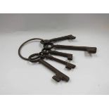 A set of five cast iron reproduction keys on ring