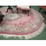 A Chinese rug, peach ground with floral design, tasselled ends,