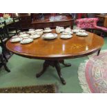 An Edwardian inlaid oval top table on quatreform base,