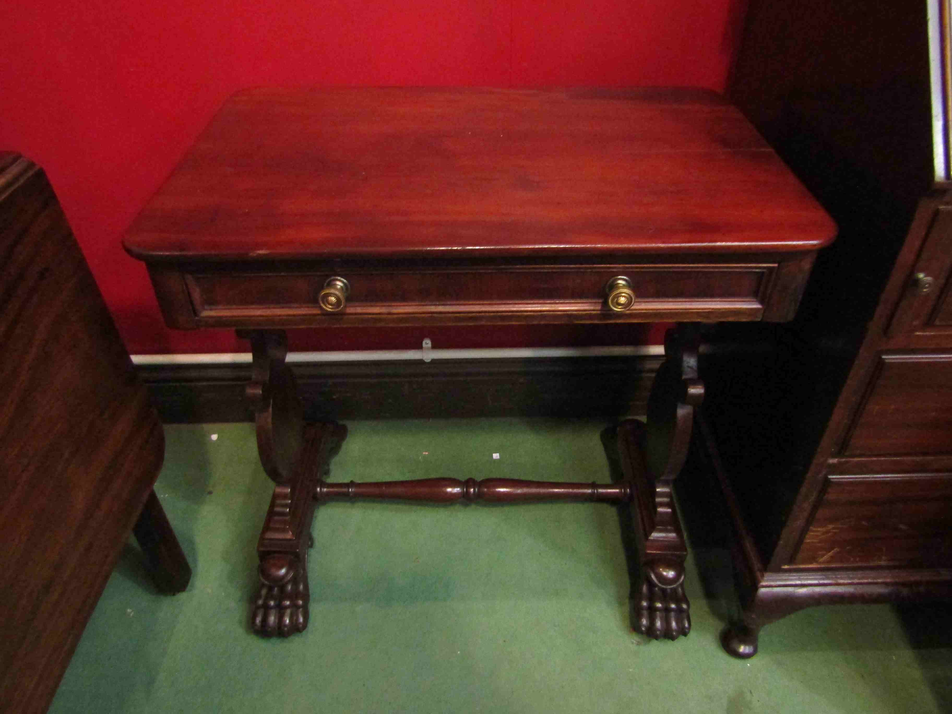 A William IV mahogany table the round cornered top over a single frieze drawer on shaped end base