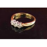 An 18ct gold three stone diamond ring, size U, 4.