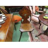 A 19th Century Black Forest chair with poker work and painted decoration the shaped back rest with