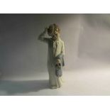 A Nao figure of boy in nightgown with slippers,