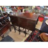 An Edwardian mahogany Georgian style occasional table the rising leaves over ring turned cabriole