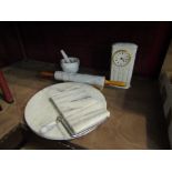 A marble cheese board, rolling pin,