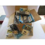 A box of mostly packaged plastic model kits including Frog and Novo