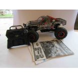 A Tamiya kit built 1:10 scale radio controlled Rock Socker 4x4 off road car with Carson remote