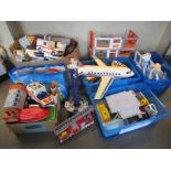 A large collection of mixed Playmobile vehicles and buildings including fire engines, ambulances,