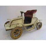 An early 20th Century Bing tinplate clockwork car in cream and gold with red seats, approx.