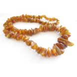 A rough cut amber necklace, 61cm long,