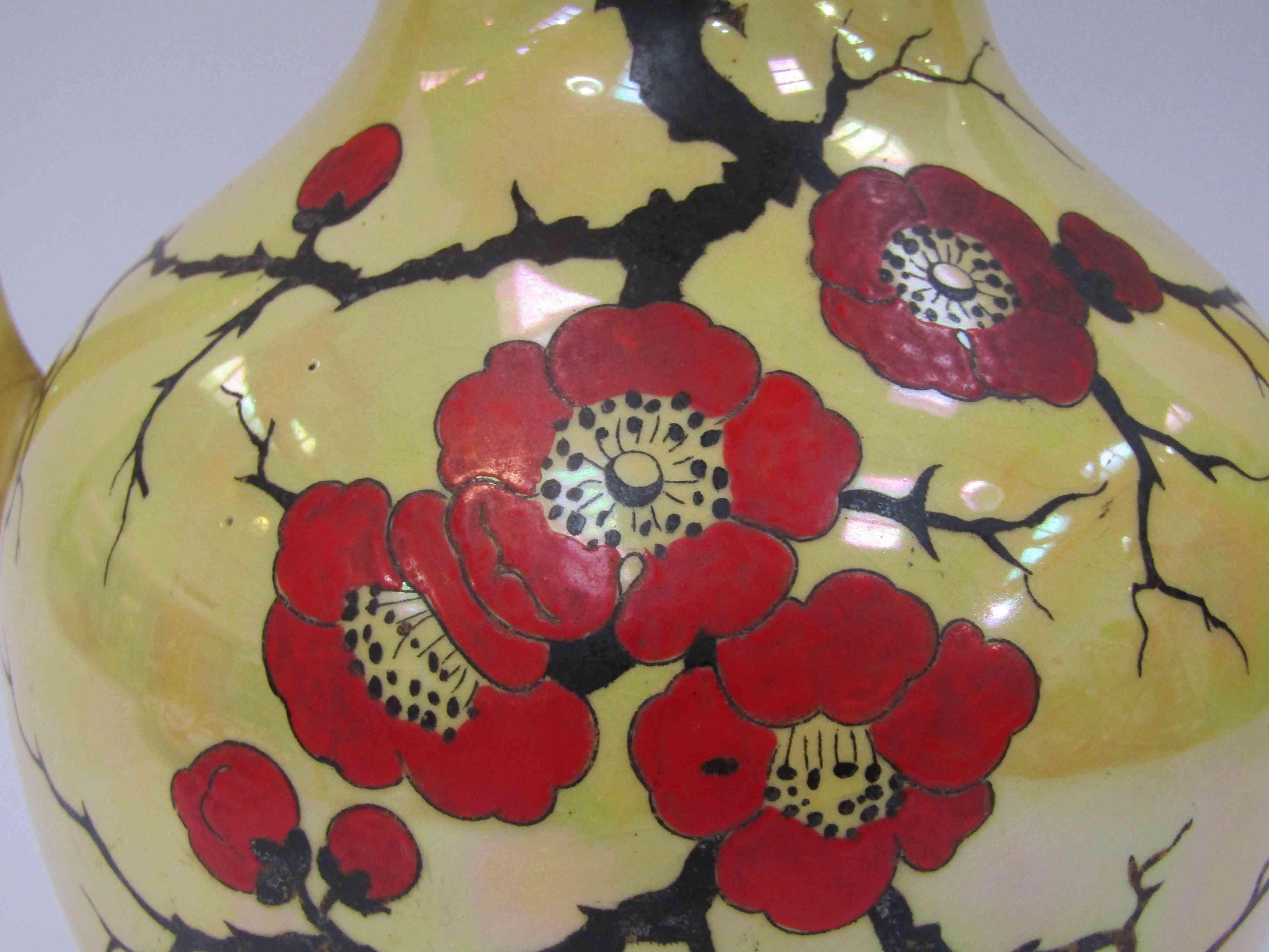 An Arcadian Stoke-on-Trent twin handled vase with lustre glaze, handpainted floral detail,