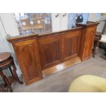 An apothecary cabinet with cupboard doors to reveal compartmental interior and side doors,