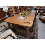 A 19th Century oak dining table with three extra leaves,