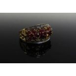 A 9ct gold ring set with three floret's of rubies,