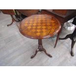 A circa 1860 circular dished top wine table with inlaid draughts / chess board decoration on turned