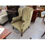 A George IV wingback armchair with ball and claw feet,