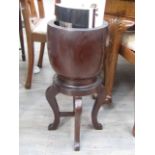 A 19th Century lignum vitae apothecary mortar on associated four legged stand,