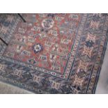 An Eastern wool blue ground rug, terracotta rectangular central panel,