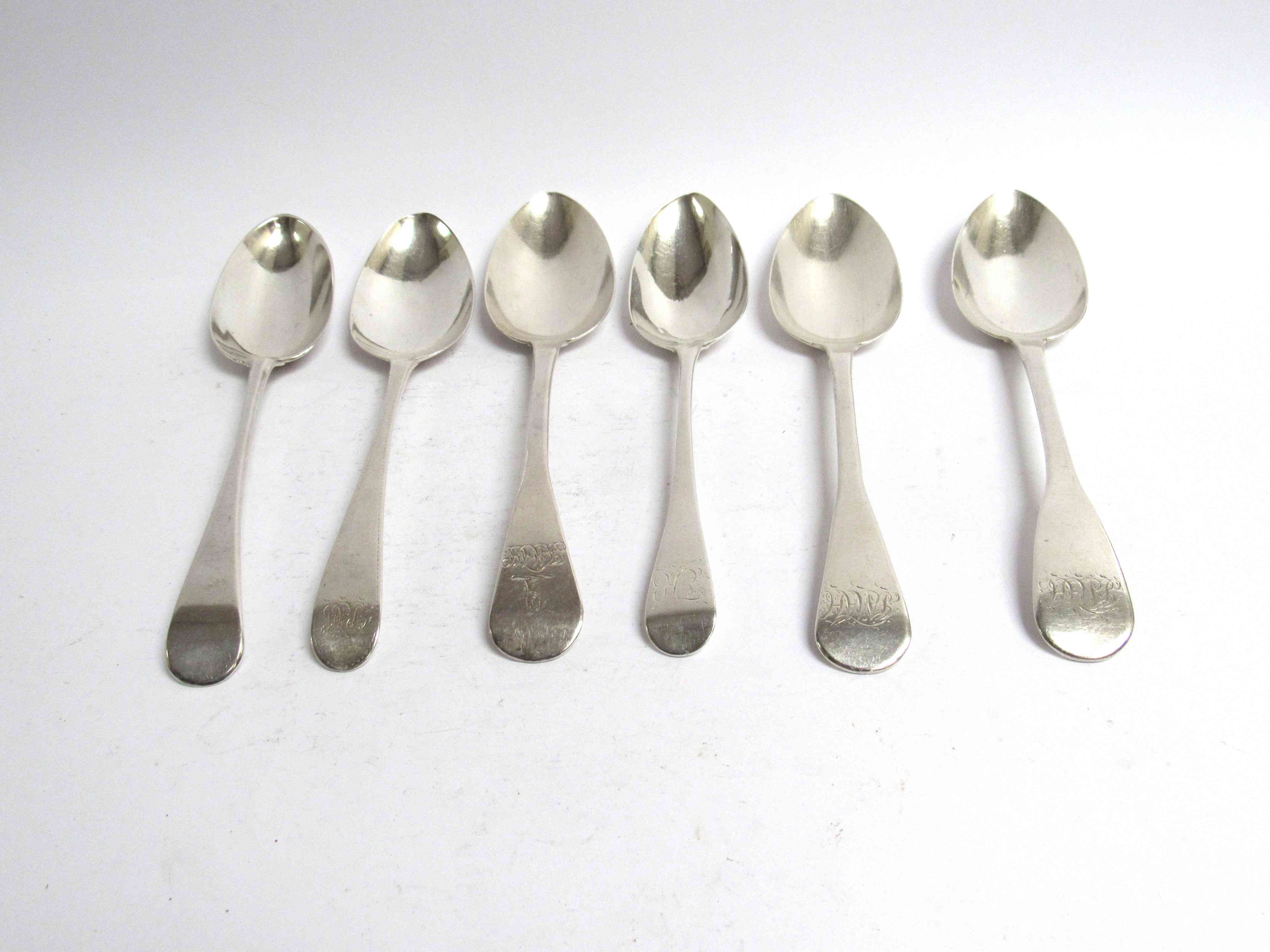 Six various Georgian serving spoons, five with monogrammed handles,