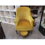 A gold velour tub chair with matching footstool
