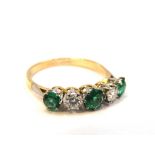 An emerald and diamond five stone ring, stamped 750/plat, .40ct diamond, .
