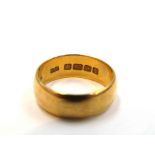 A 22ct gold wedding band. Size M, 5.