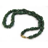 A green jade bead necklace,