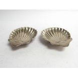 A pair of Josiah Williams silver scallop form dishes, London 1920, 10cm long,