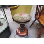 A Victorian mahogany music stool with tapestry top