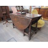 An early 18th Century oak drop leaf dining table with single end drawer,