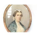 A 19th Century oval miniature on ivory, portrait of a woman in blue shawl. Signed Cosway lower left.