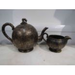 A Chinese Wan Hing silver teapot and milk jug, bamboo leaf design, stamped to base with 90,