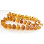 A chunky amber necklace hand knotted, 63.
