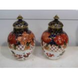 A pair of Royal Crown Derby Imari pattern 2444 lidded vases,