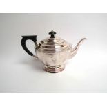 An Atkin Brothers silver teapot, faceted sides, ebonised handle, Sheffield 1935,