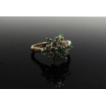 A 9ct gold cluster ring set with seven emeralds and six diamonds. Size M, 3.