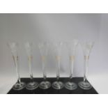 A set of eight crystal and etched trumpet champagne glasses (two a/f), 23.