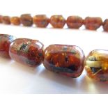 An amber bead necklace, 60cm long,
