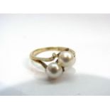 A 9ct gold pearl set cross over ring. Size J, 1.
