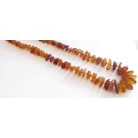 A rough cut amber necklace, 61cm long,