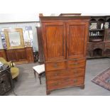 A George III flame mahogany gentleman's wardrobe, the two doors opening to reveal tray space,